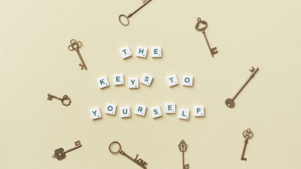 Motivational message with antique keys and letter blocks on yellow background.